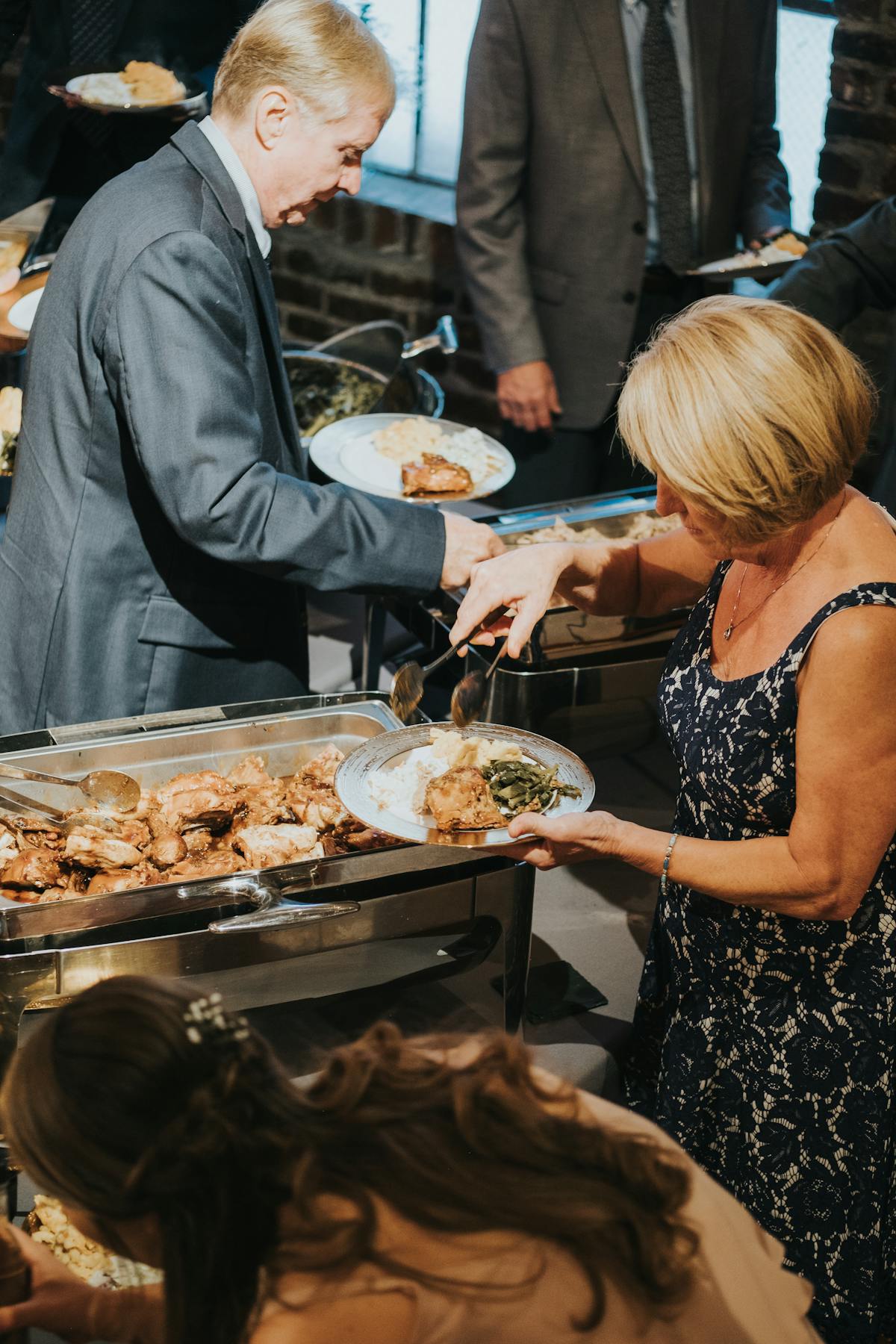 a group of people preparing food on a table