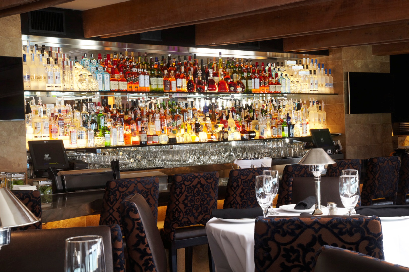 a bar with many bottles of alcohol