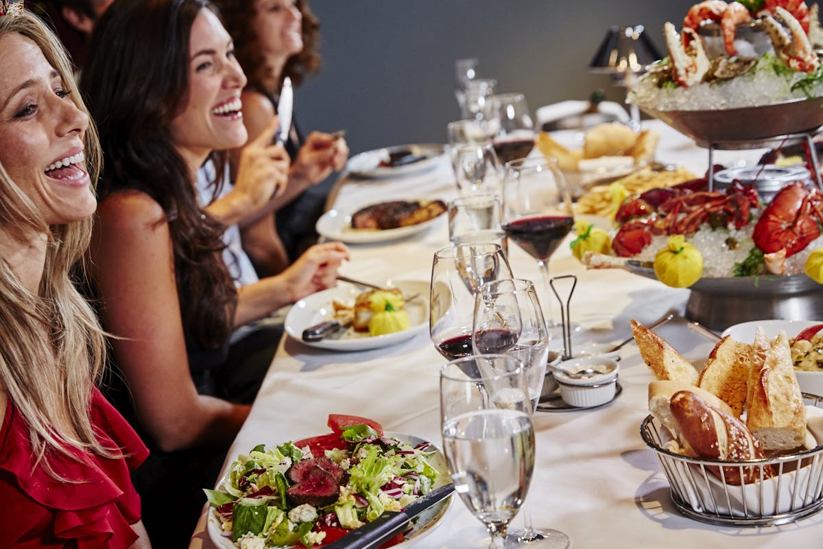 a woman sitting at a table with a plate of food