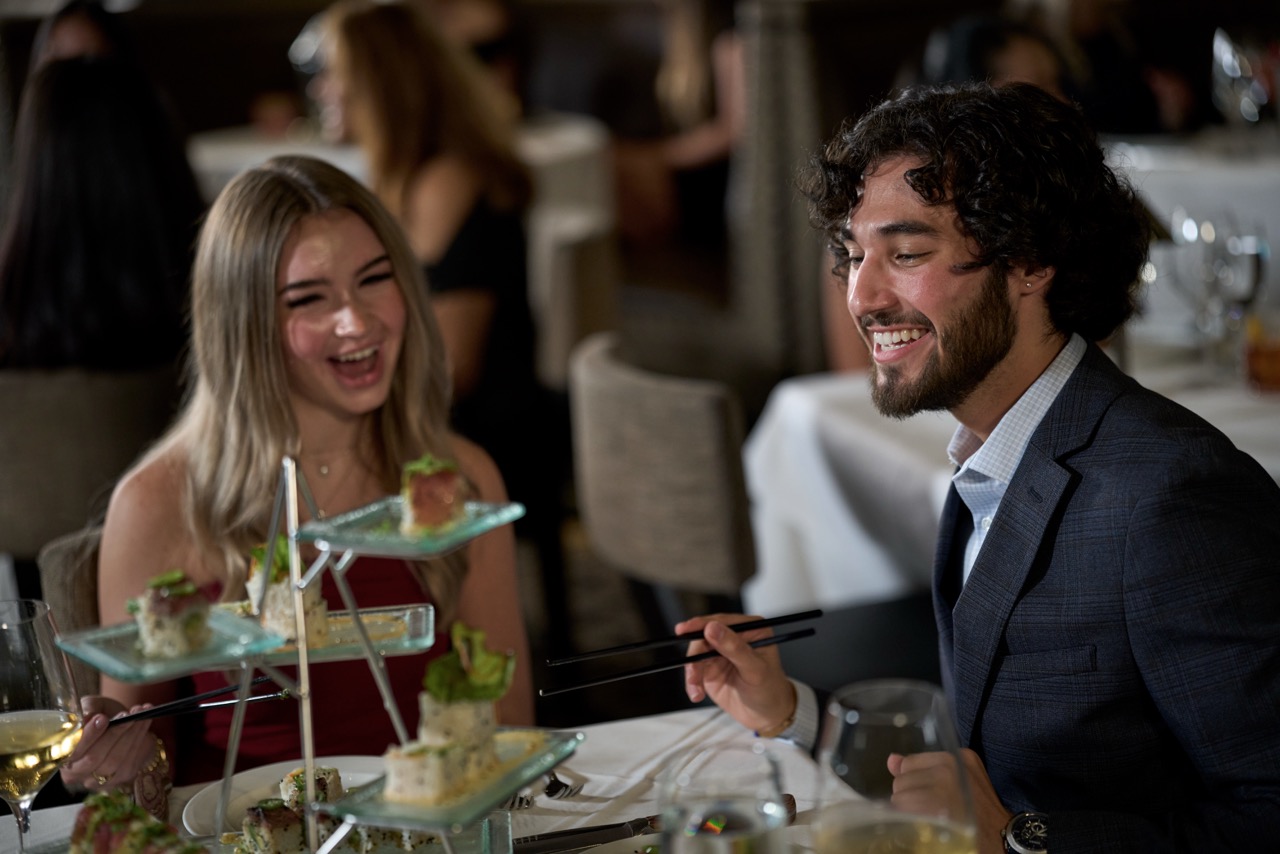 a man and woman eating at a restaurant