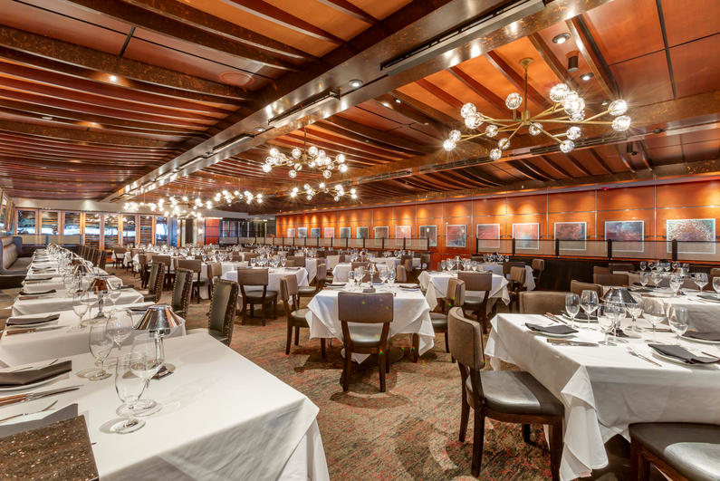 a group of people sitting at a table in a restaurant