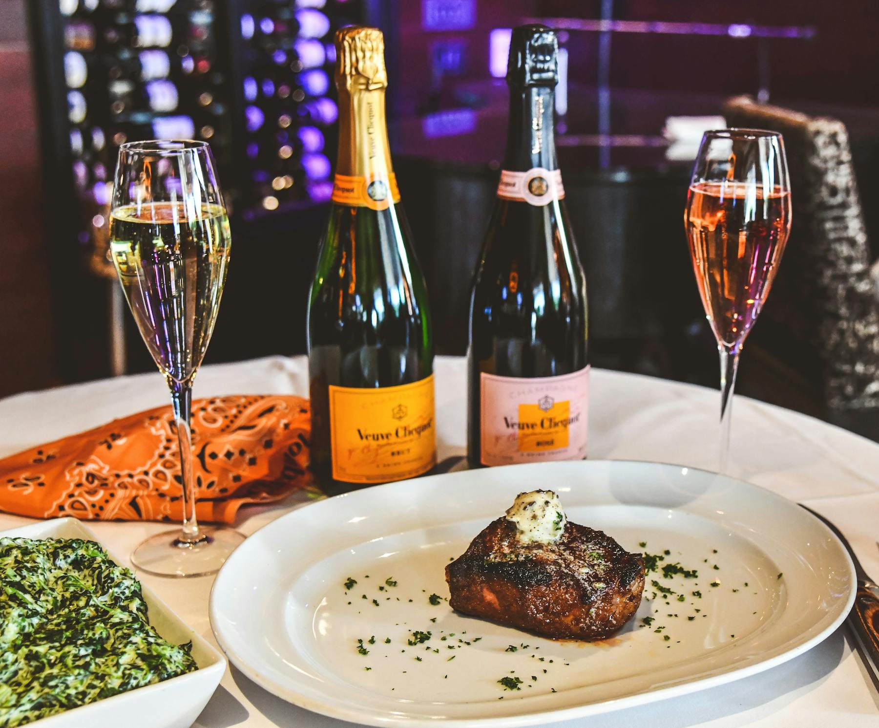 a plate of food and a bottle of wine on a table