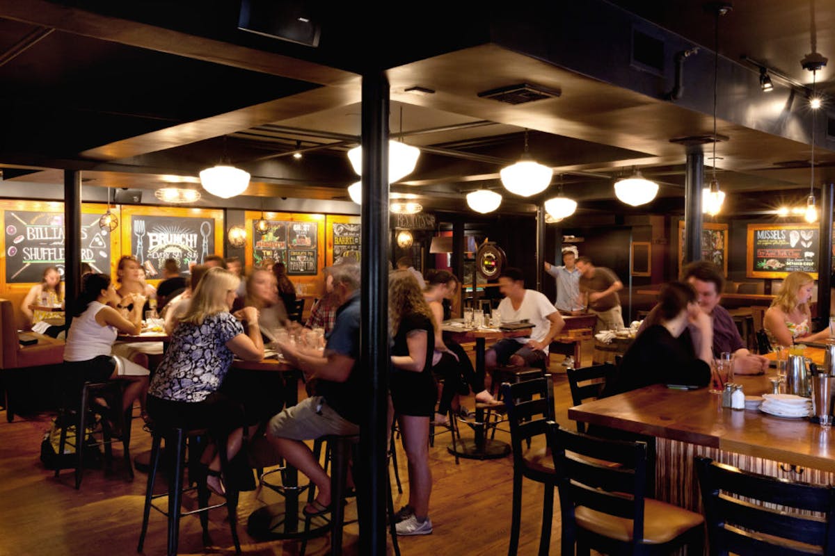 a group of people sitting at a table in a restaurant