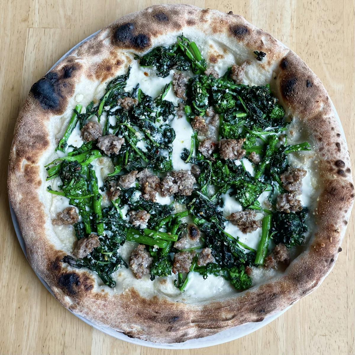 a pizza sitting on top of a wooden cutting board