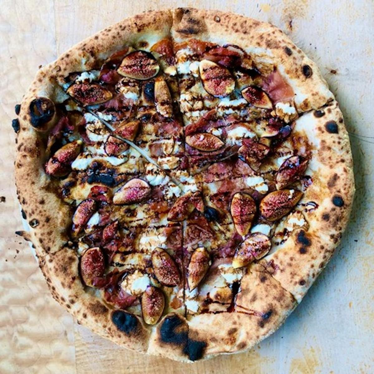 a pizza sitting on top of a cutting board