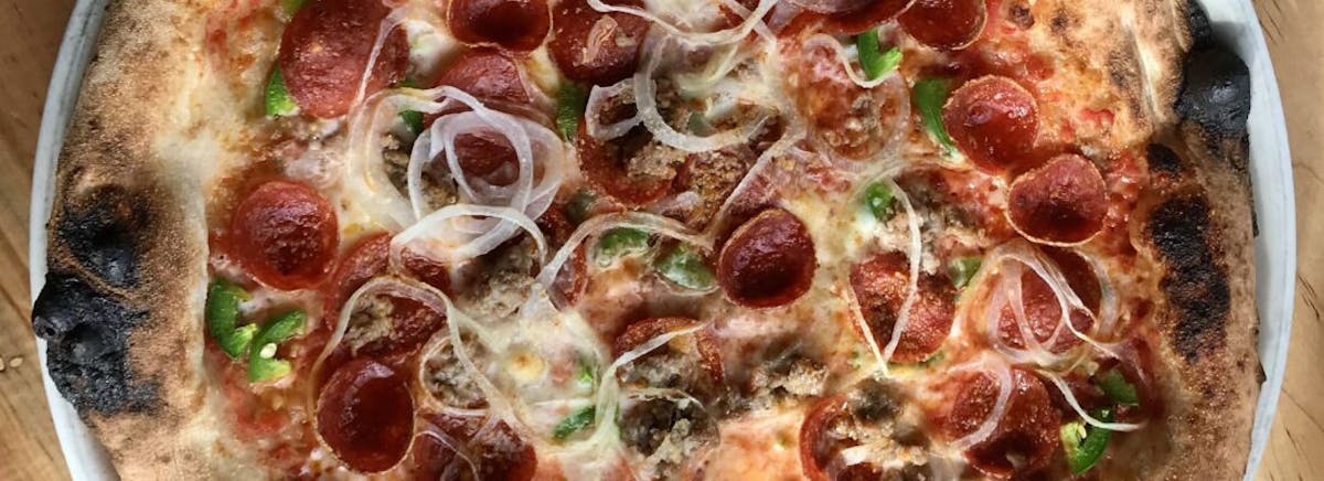 a close up of a slice of pepperoni pizza