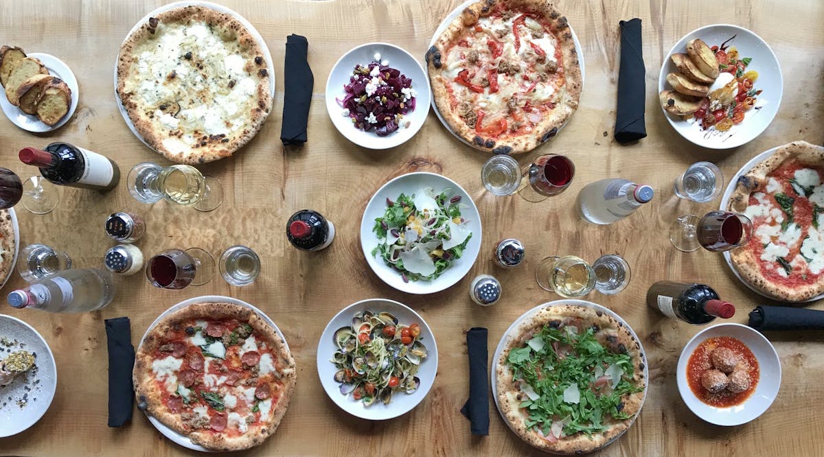 a bunch of food sitting on top of a wooden table