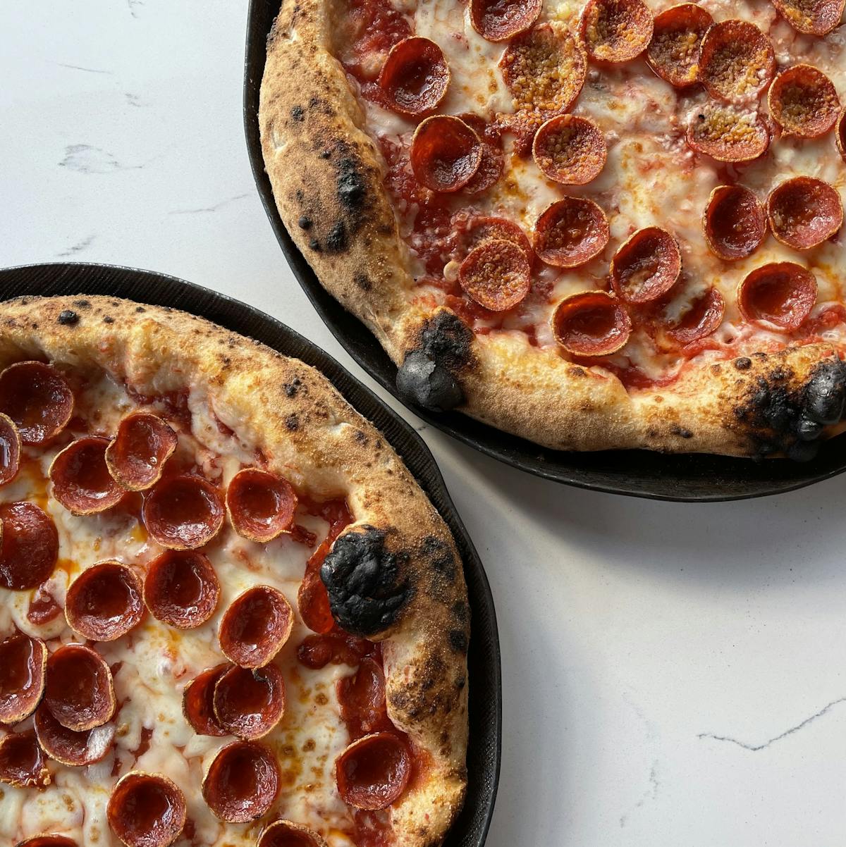 a pepperoni pizza sitting on top of a table