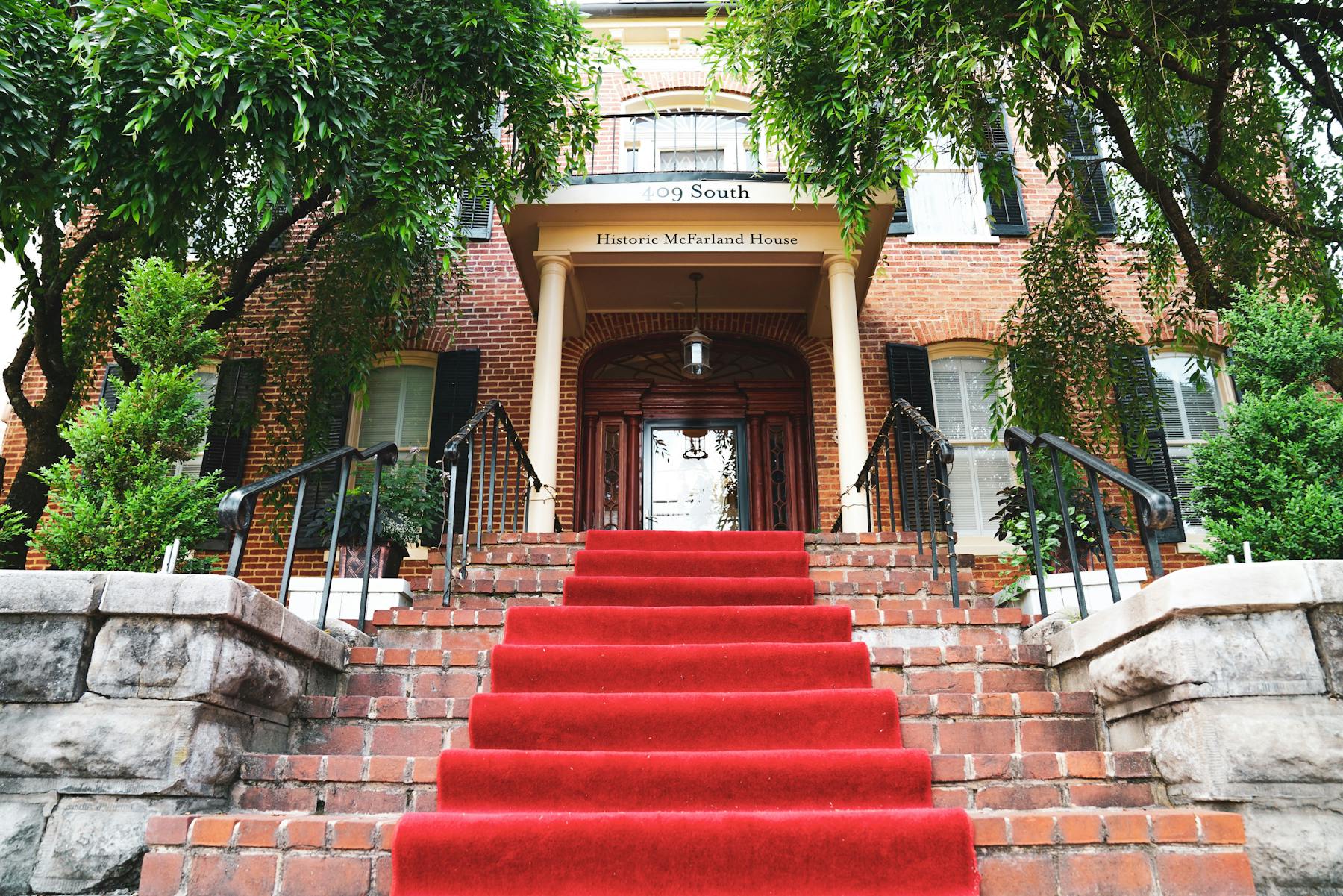 a brick staircase decorated with a red carpet