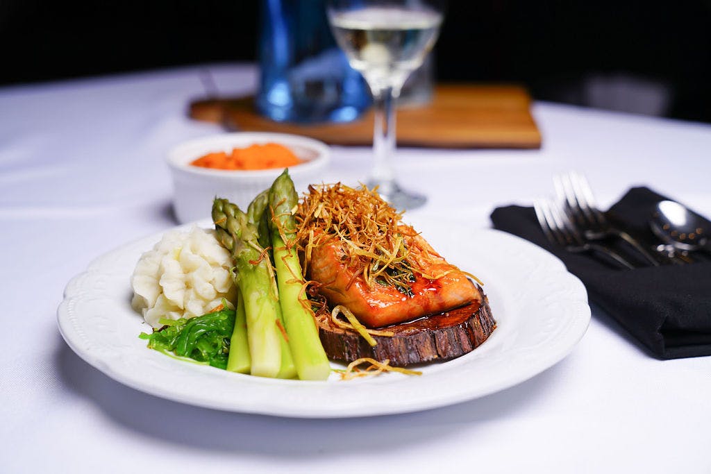 a plate of food and a glass of wine