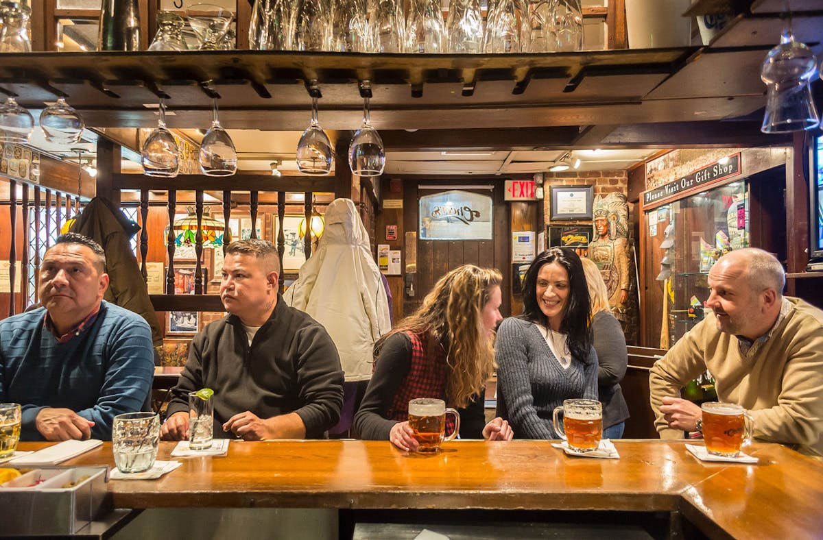 a group of people sitting at a table in a restaurant