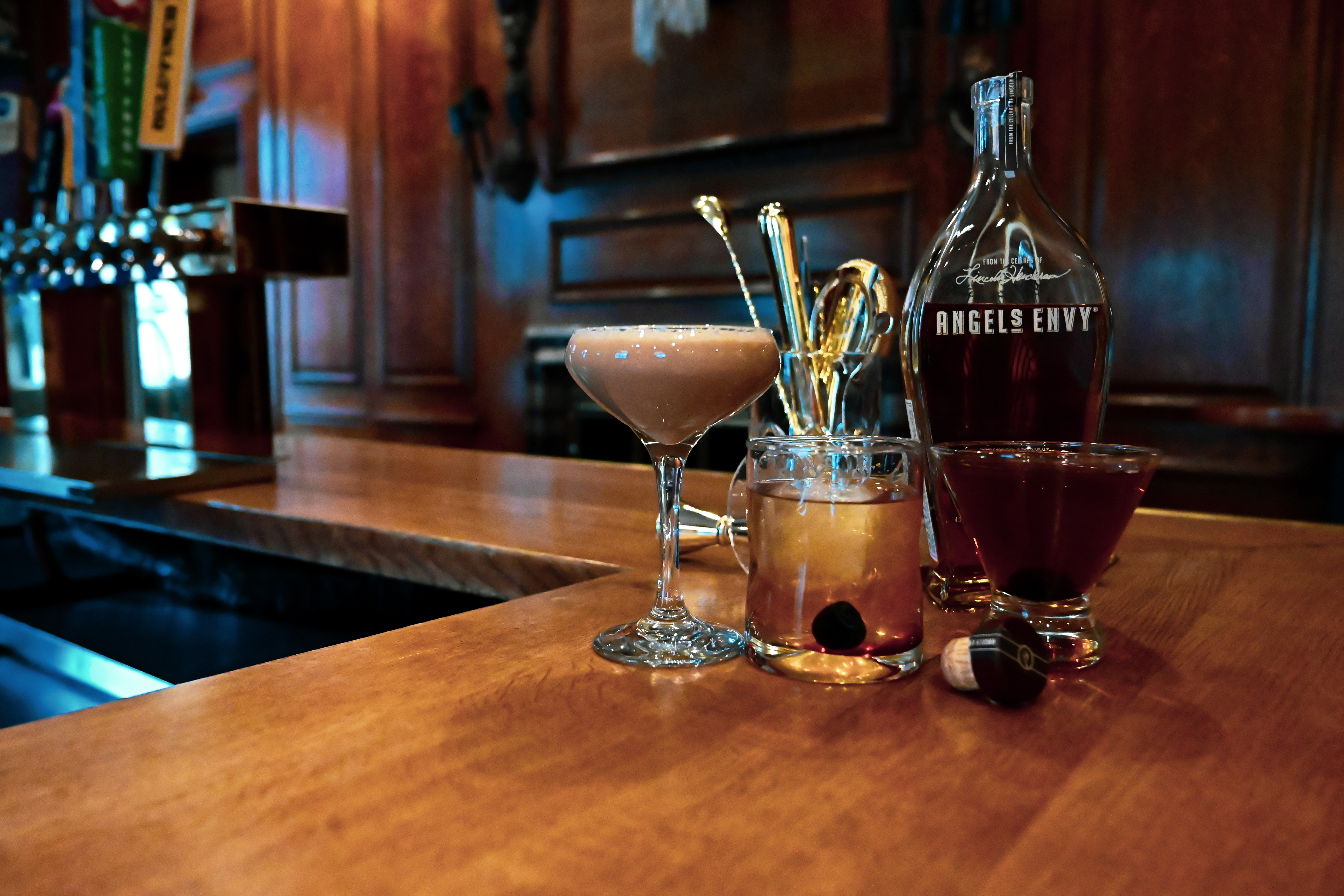 a glass of wine sitting on top of a wooden table