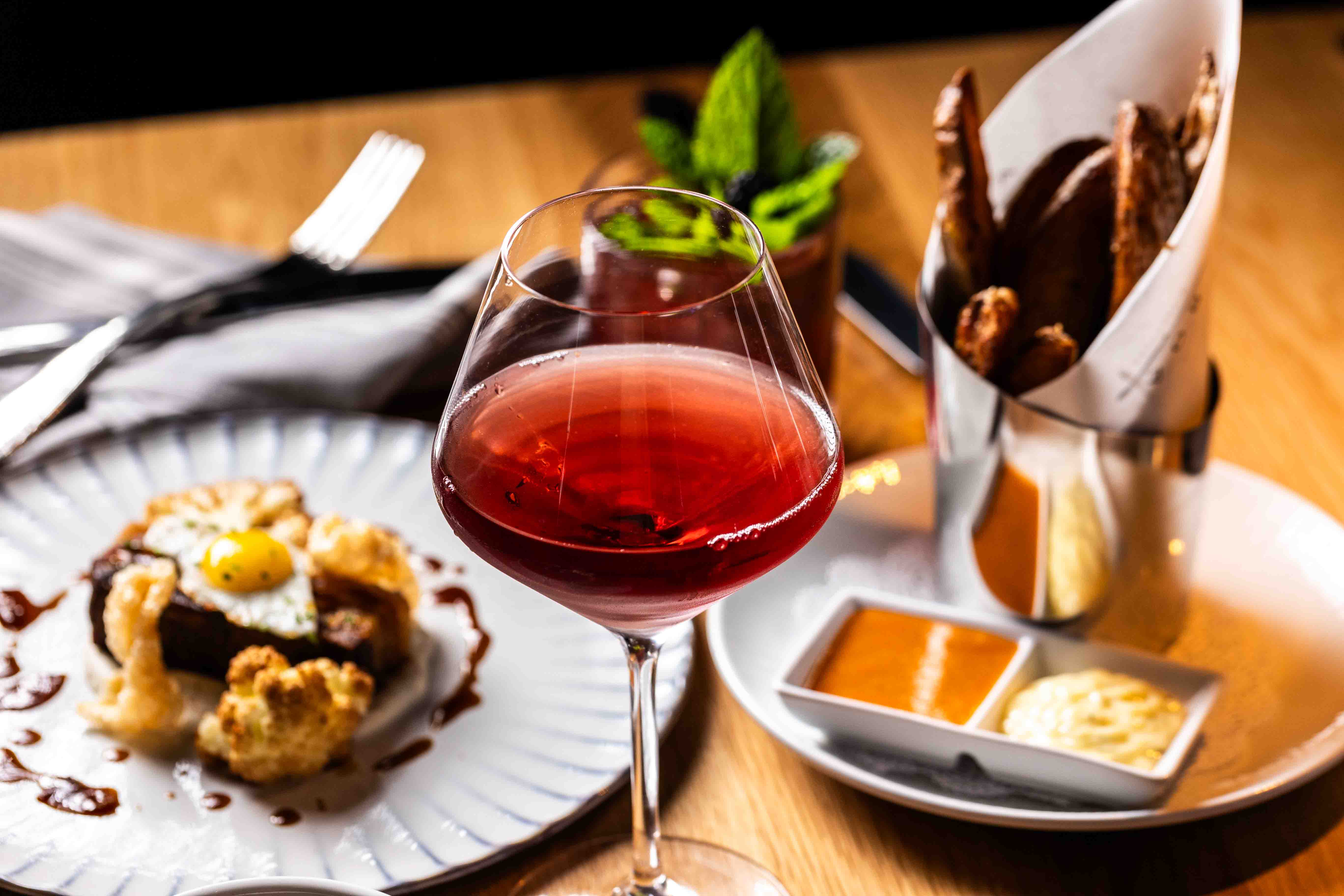 a plate of food and a glass of wine