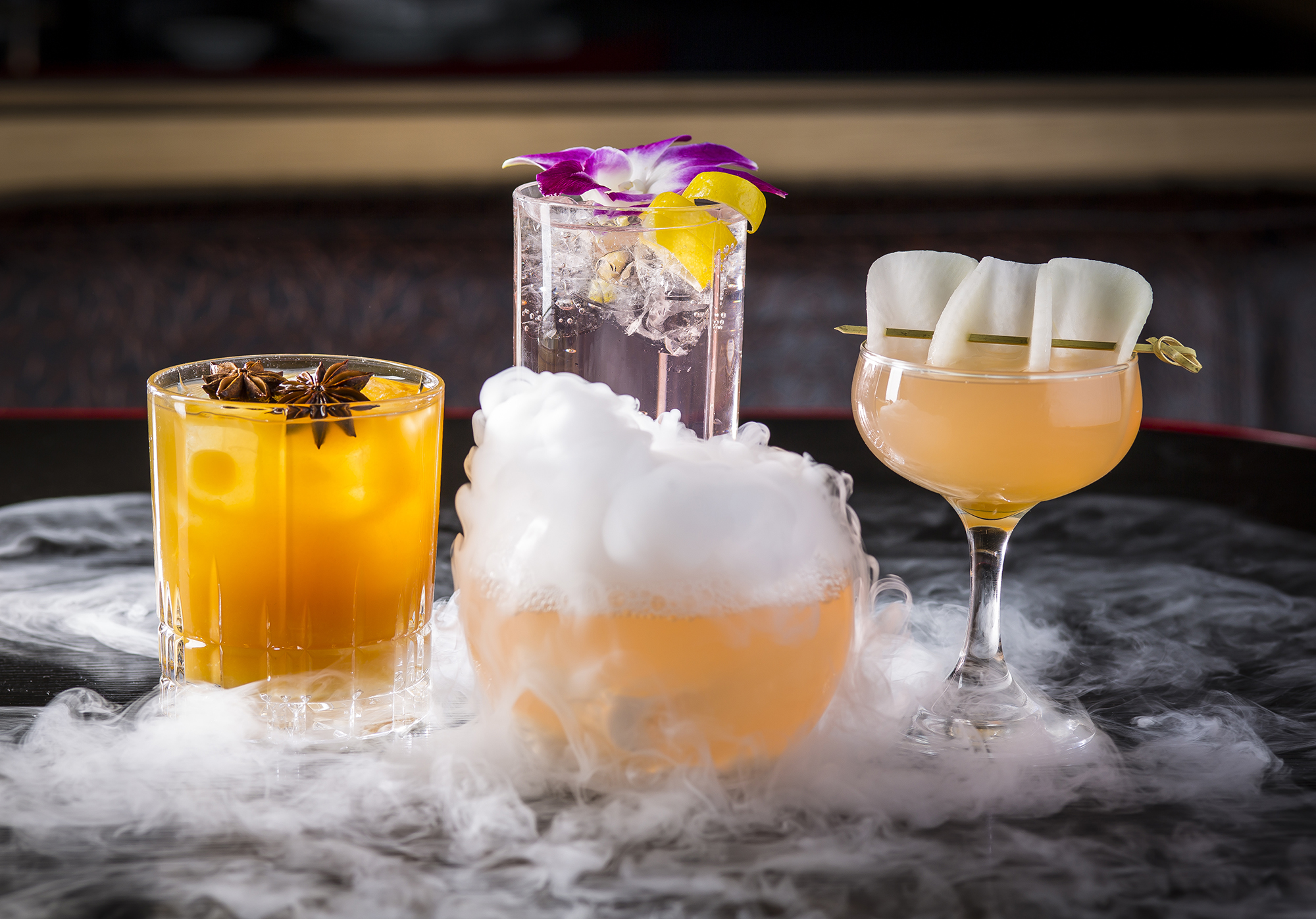 a glass of orange juice next to a cup of water