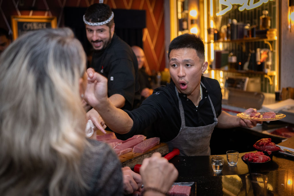 a man in an apron holding a woman's hand