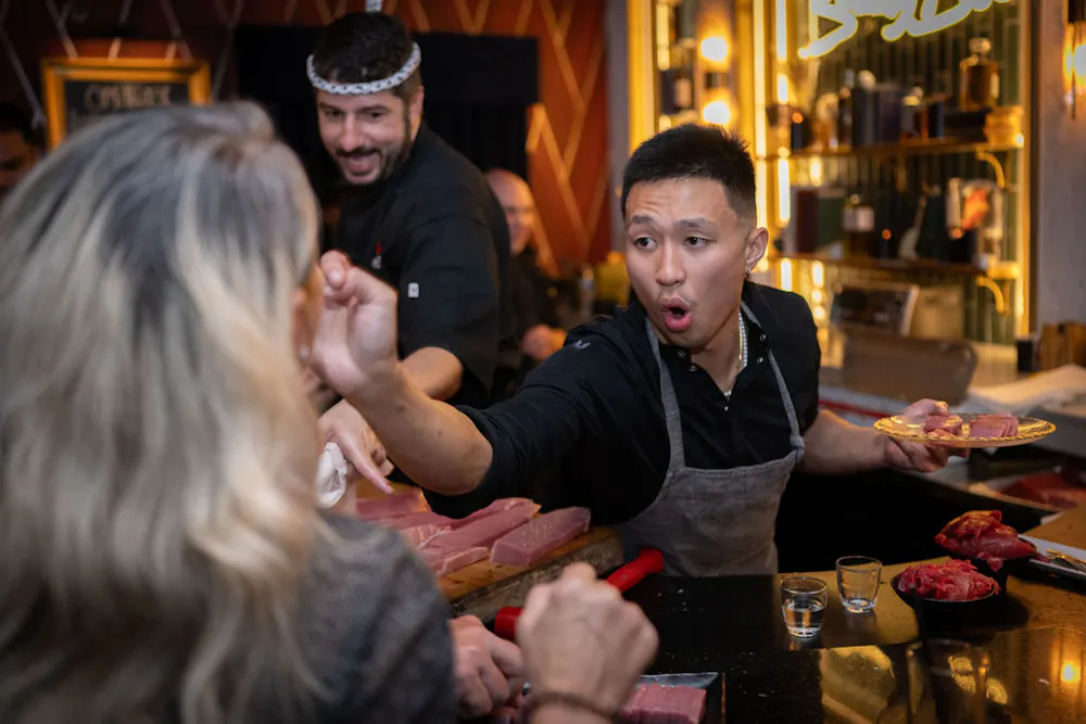 a man in an apron holding a woman's hand