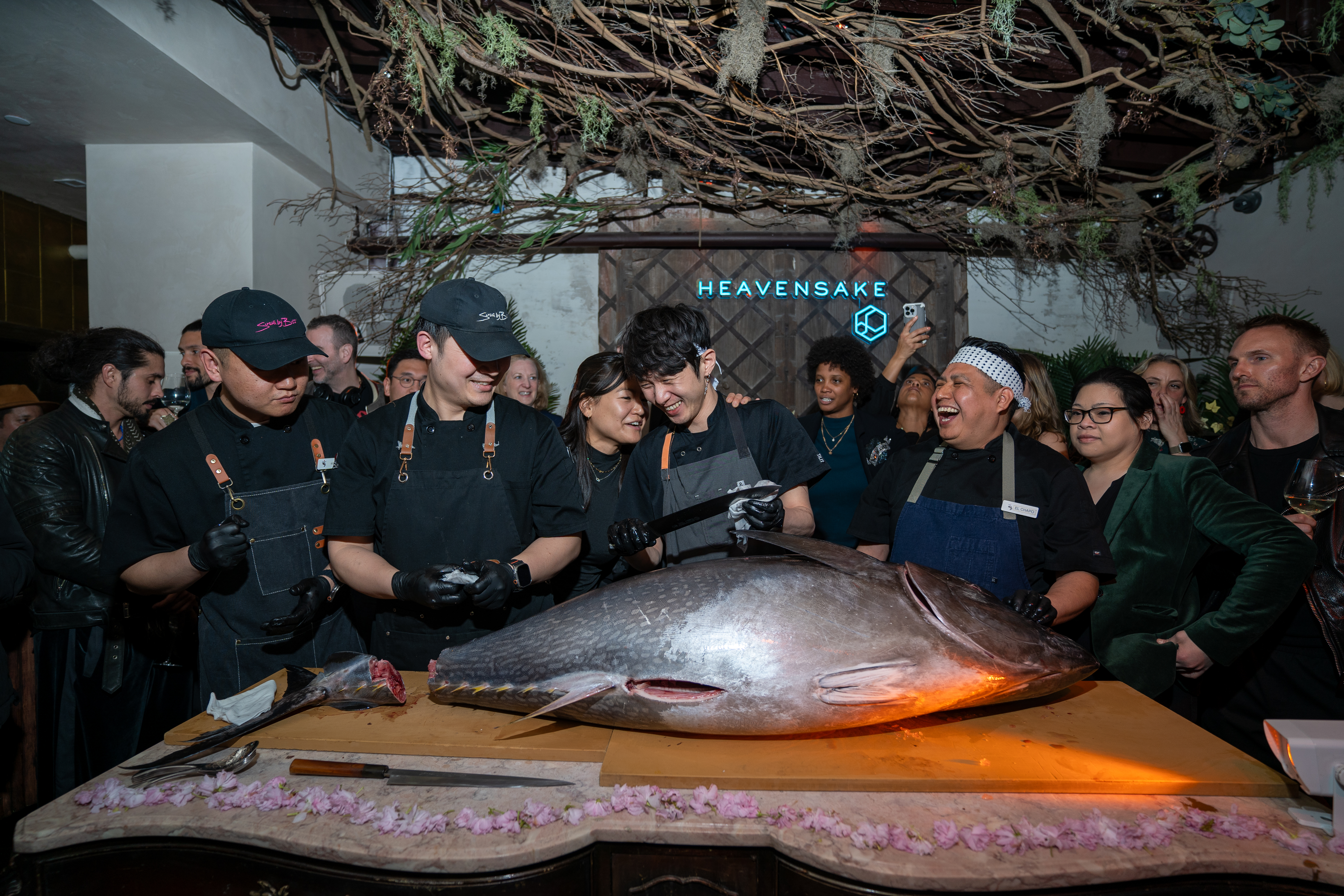a group of people standing in front of a fish