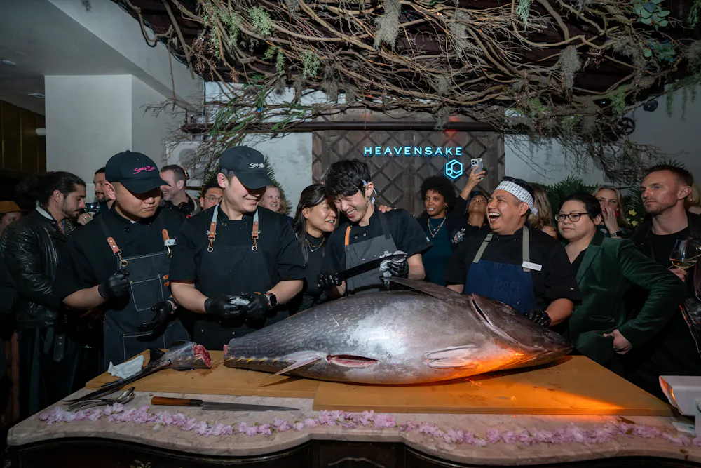 a group of people standing in front of a fish
