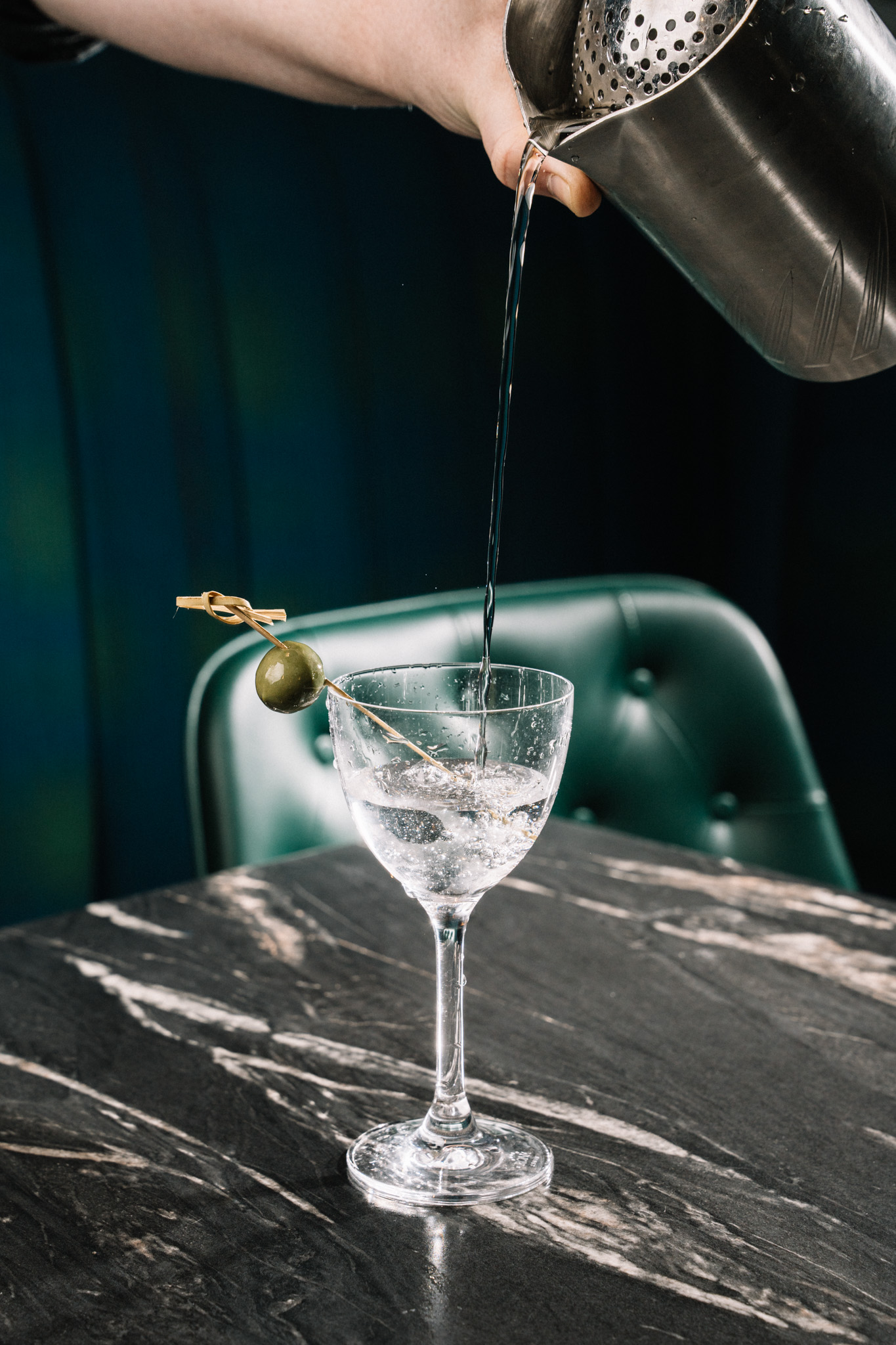 a hand holding a glass of wine