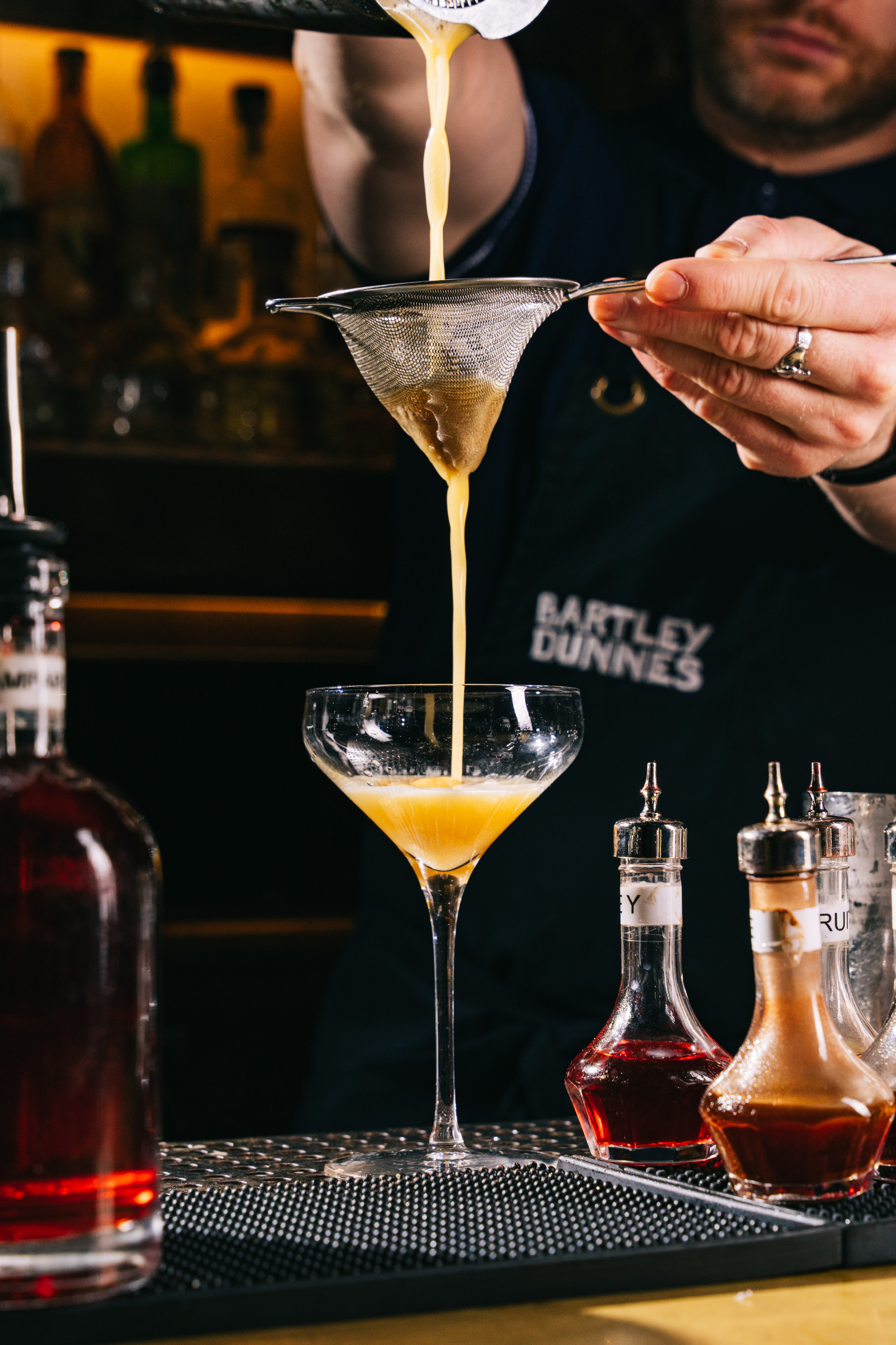 a man sitting at a table with wine glasses