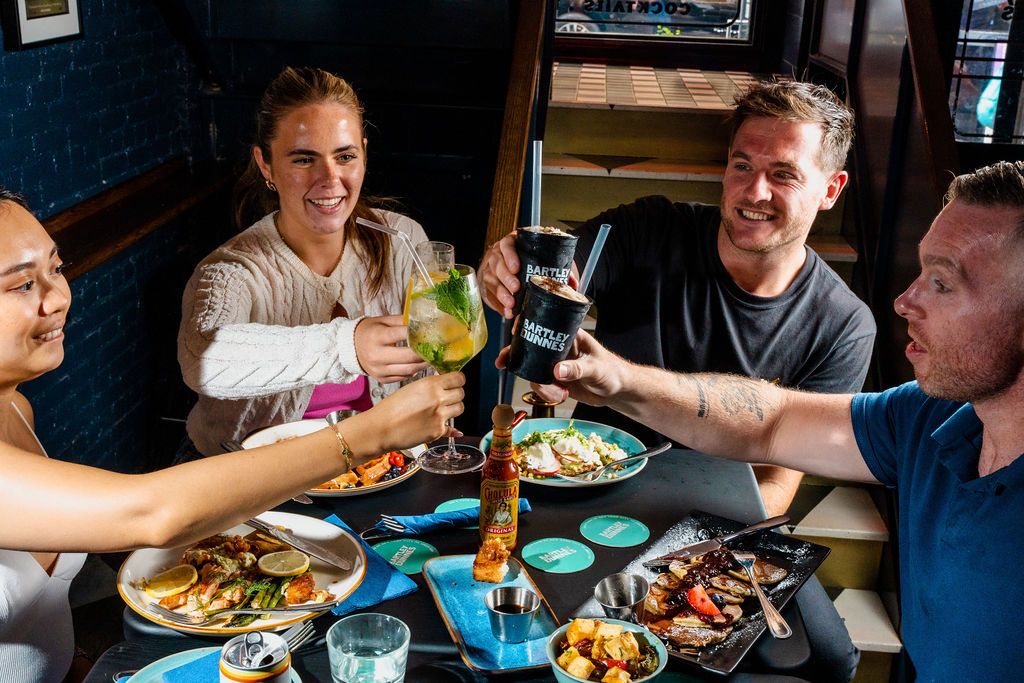 a group of friends toasting at brunch