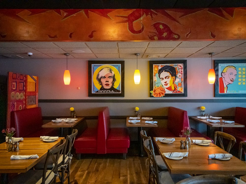 Andy Warhol, Frida Kahlo sitting at a table in a room