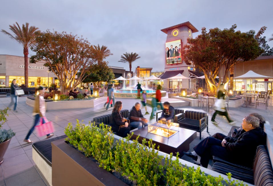 a group of people sitting at a table in front of a building